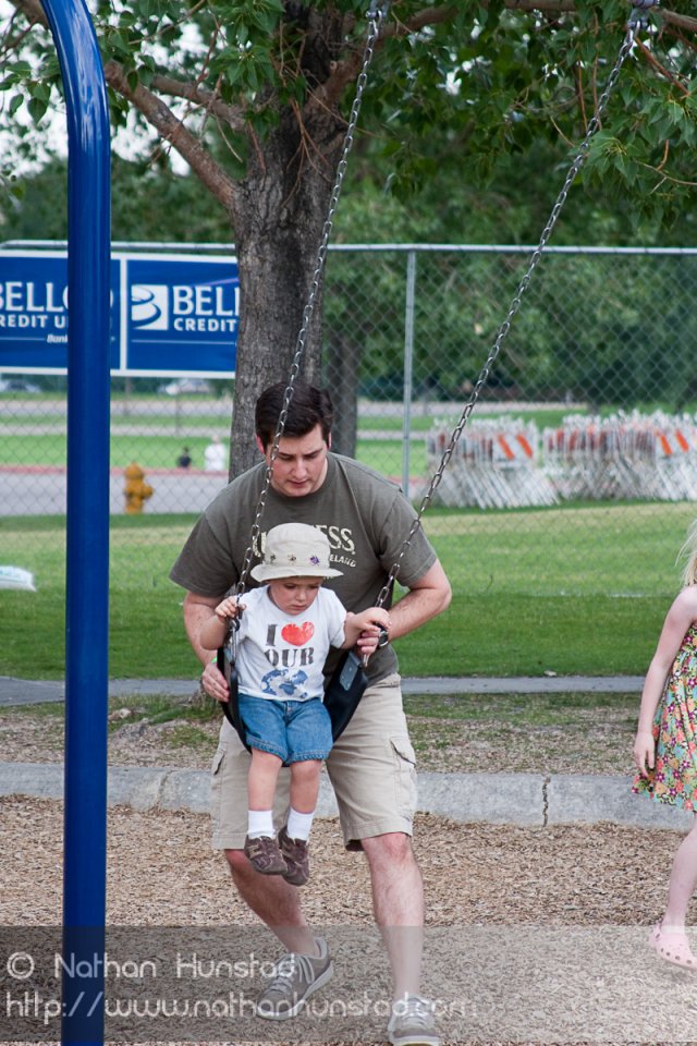 Chris and Michael Weber playing on the swings at the Colorado Irish Festival